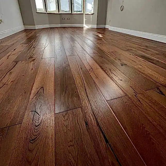 Antique double smoked oak flooring fully installed in a room, showing natural character