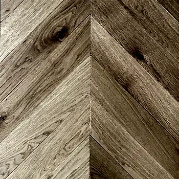 Close-up of Chevron Natural Oak UV Oiled flooring revealing layered wood grain, subtle tonal variation, and the flowing precision of the chevron pattern
