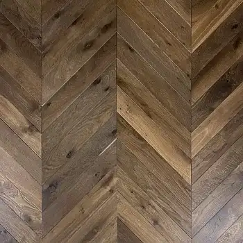 Close-up of Double Smoked Chevron Oak flooring showing authentic aged texture, rich smoked tones, and brushed & oiled finish