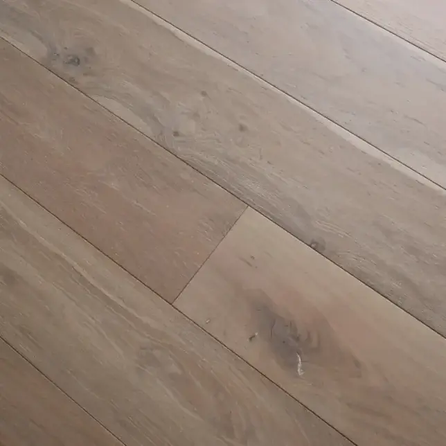Angled image showing Eco Range Iceberg Oak flooring with light brushed texture and oil-enhanced pale oak surface tones