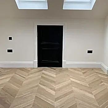 Luxury chevron invisible oak brushed and oiled flooring installed across a bright interior, showcasing the chevron pattern and elegant finish